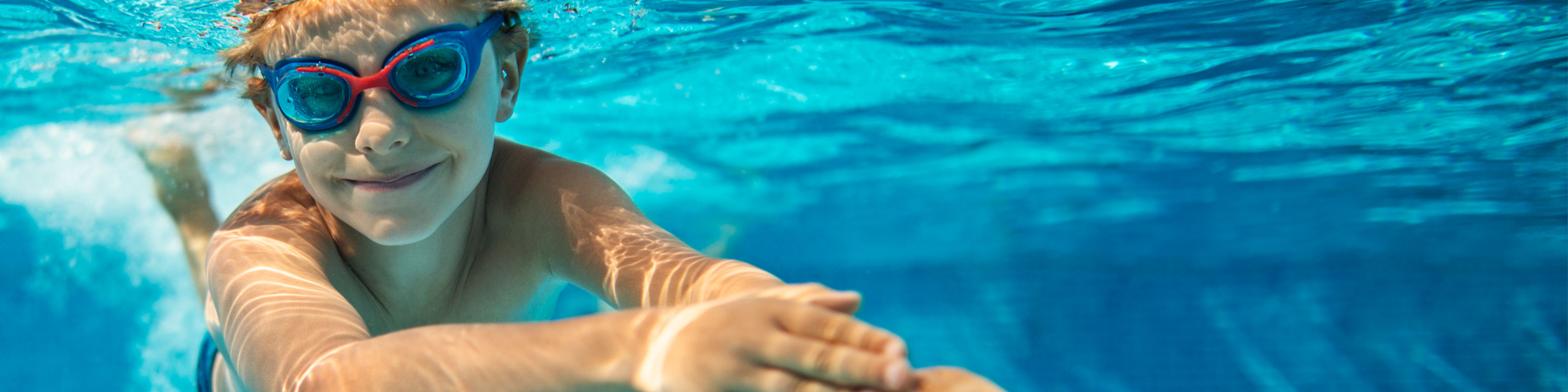 Boy Swimming in Pool