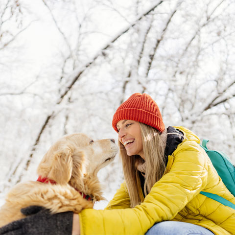 Woman and dog outdoors in snow