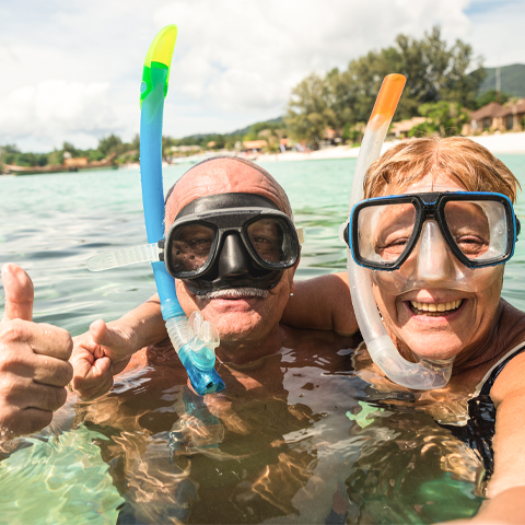 Senior couple snorkeling