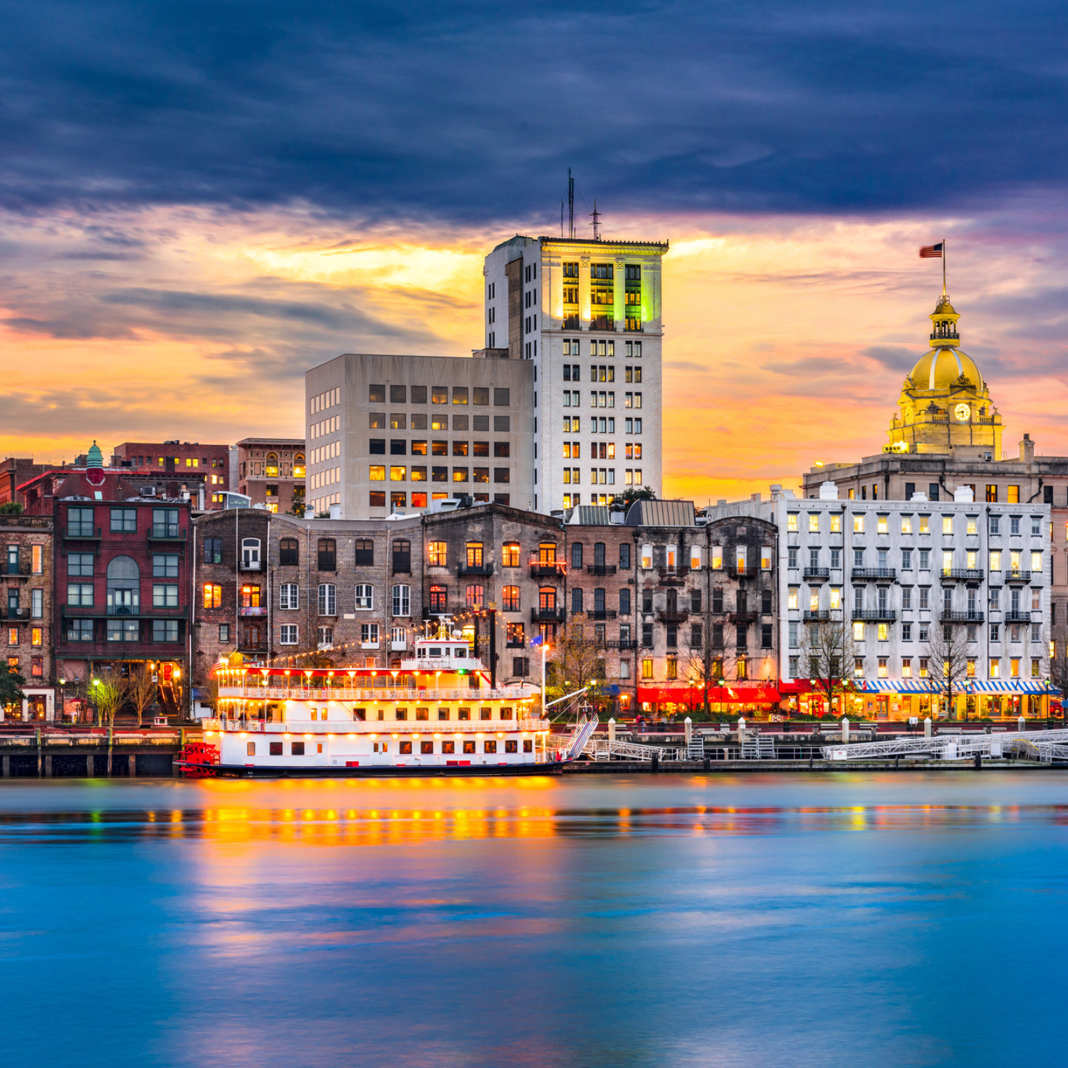 Riverside view of Savannah with old buildings and boat in river