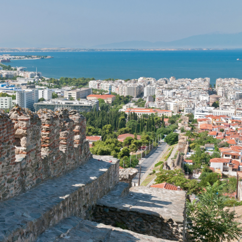 An old city wall in Thessalonika, with the aegean sea and mount olympus in the background