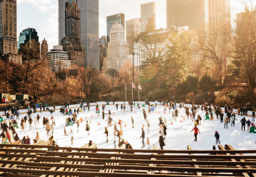 Central park of new york city during winter with several ice skaters