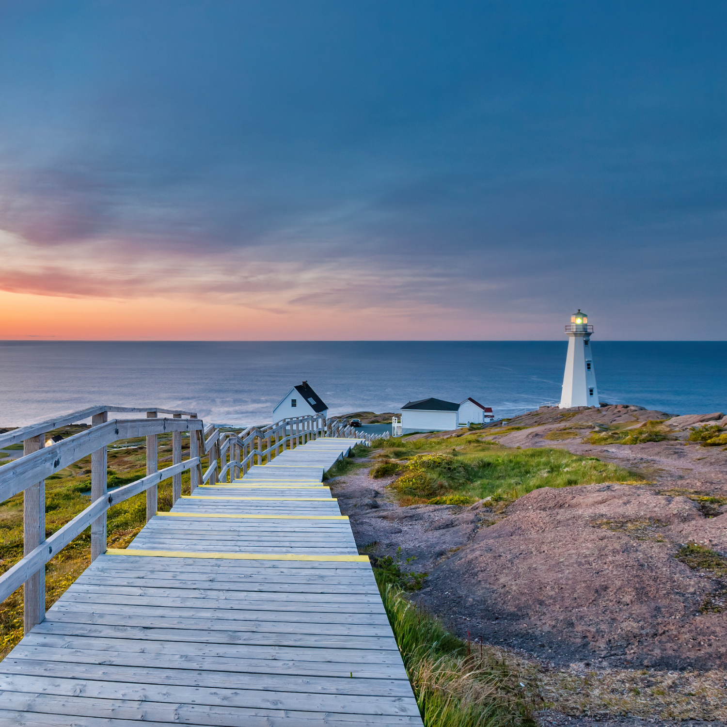 Boardwalk leading to the Cape Spear Lighthouse near St John's, Newfoundland, Canada at sunset. Cape Spear is the most easterly point in Canada.