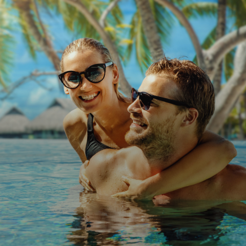 Senior couple floating in pool
