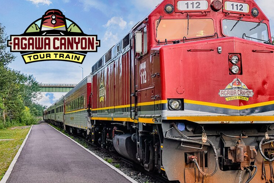 Red train on track in Agawa, with Agawa Train Tour logo