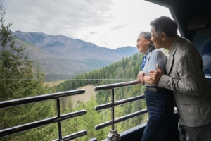 couple looking out at mountains in GolfLeaf Service with Rocky Mountaineer