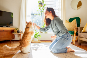 Woman giving cat treats