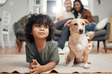 Little boy with his dog in the living room