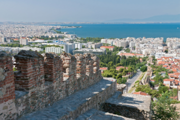 An old city wall in Thessalonika, with the aegean sea and mount olympus in the background