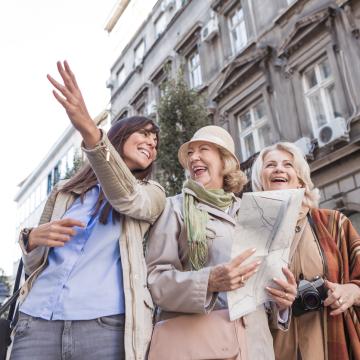 ladies exploring the city, looking at map