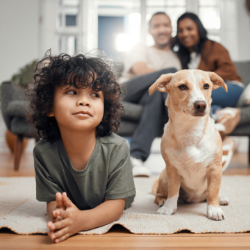 Little boy with his dog in the living room
