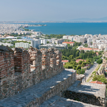 An old city wall in Thessalonika, with the aegean sea and mount olympus in the background