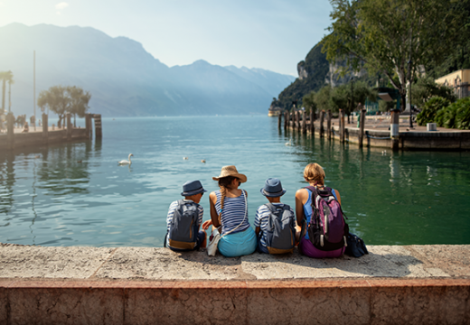 Family sitting in harbor of Riva del Garda