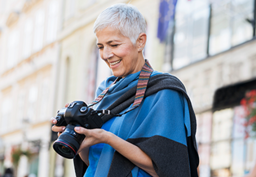 Woman reviewing photos on camera while on vacation