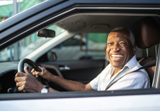 smiling senior driver in car