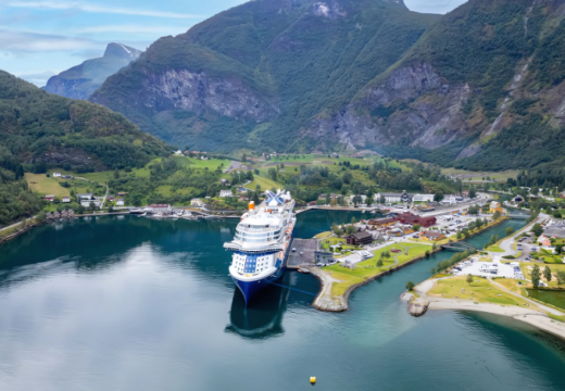 Celebrity Cruise ship at port call in Scandinavian country with mountains in background
