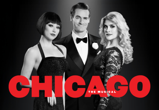 Man standing in between two women with CHICAGO underneath