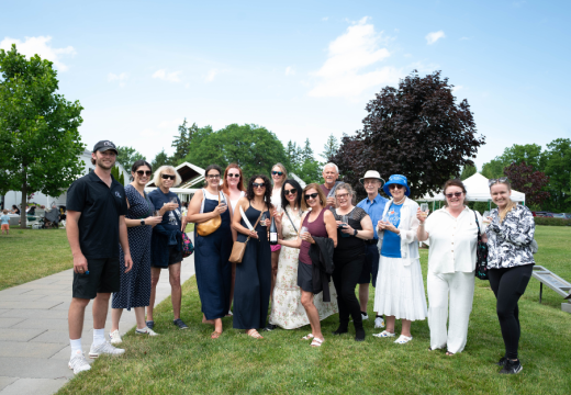 group of people outside enjoying wine on a summer day