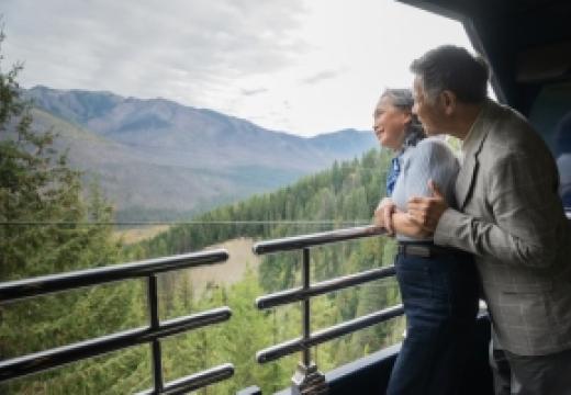 couple looking out at mountains in GolfLeaf Service with Rocky Mountaineer