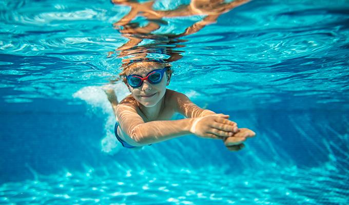 Boy Swimming in Pool