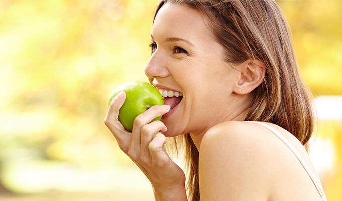 Woman eating apple