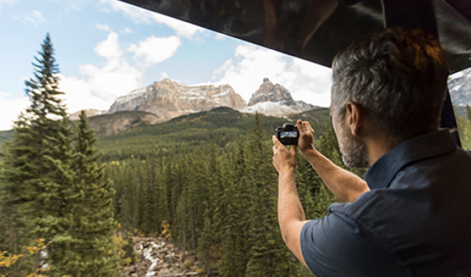 Man taking photo of Canadian Rocky Mountains