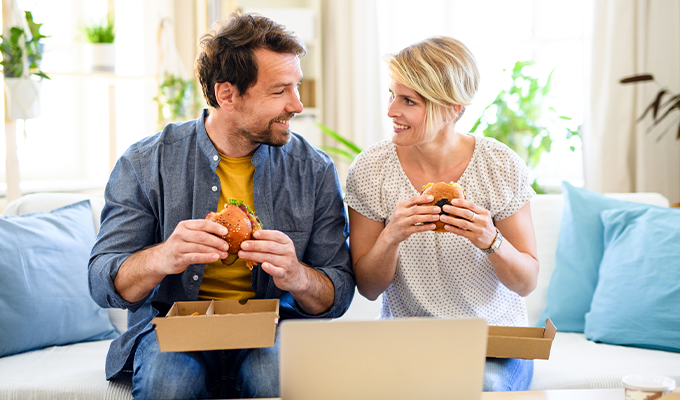 Couple eating food at home