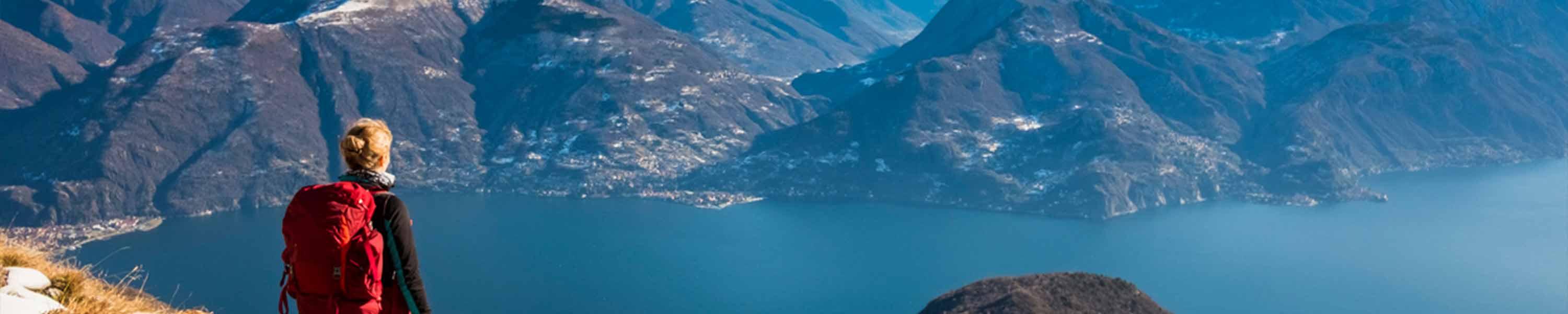Woman hiker on mountain looking at lake