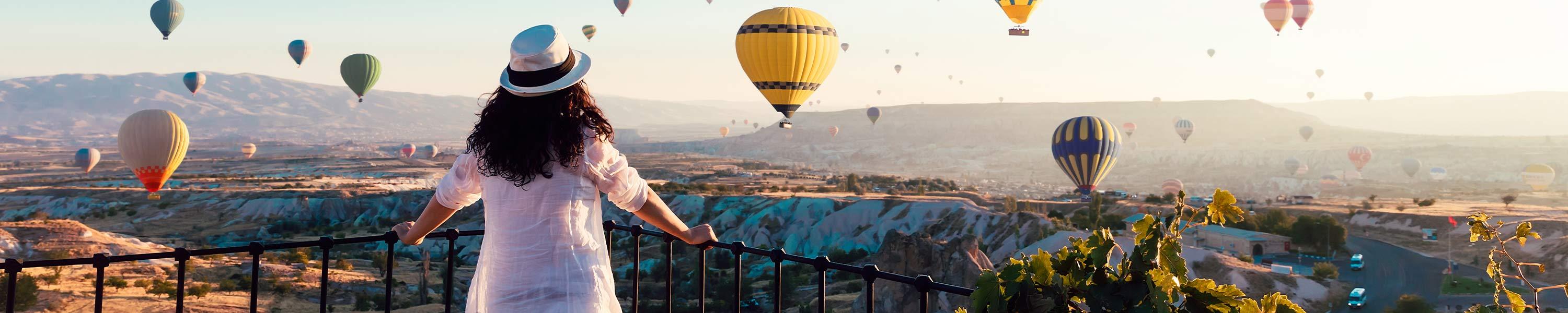 Tourist looking out to hot air balloons
