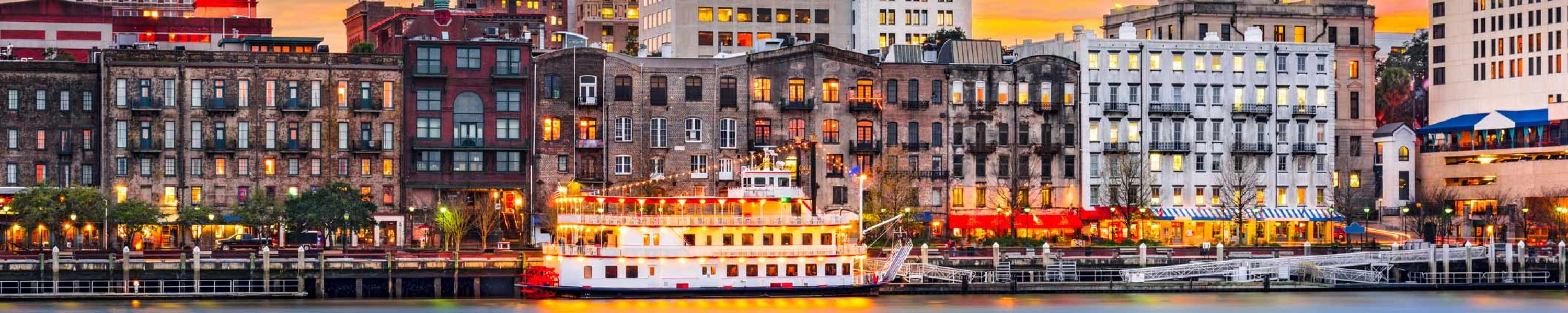 Riverside view of Savannah with old buildings and boat in river