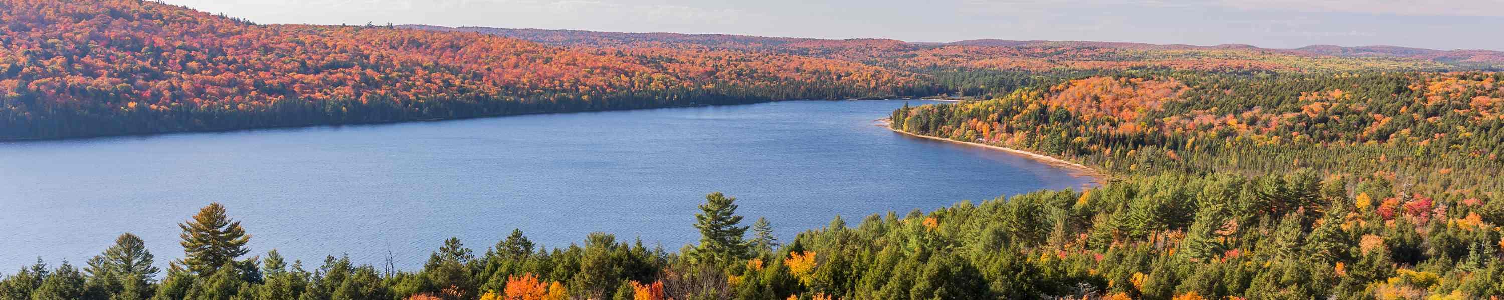 Overlooking a lake surrounded by brilliant fall foliage - Algonquin Provincial Park, Ontario, Canada