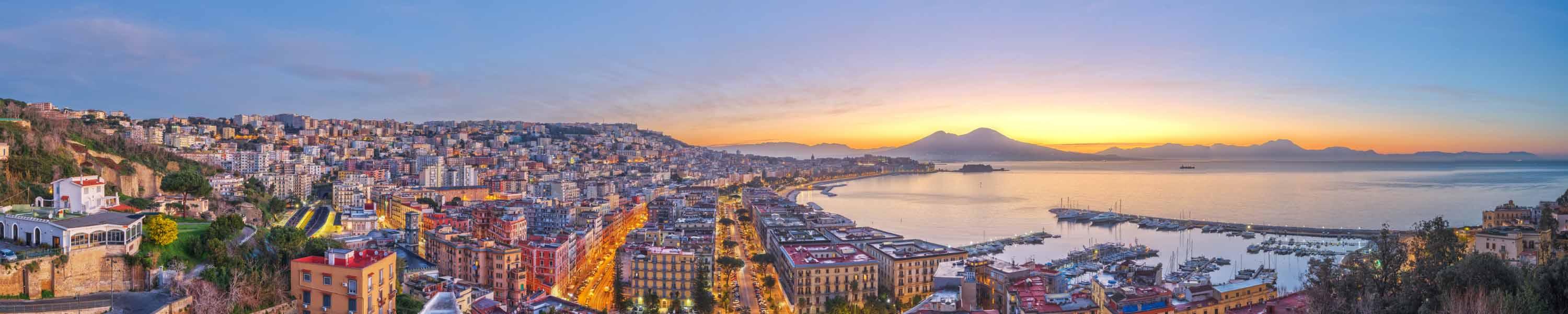 Naples, Italy aerial skyline on the bay with Mt. Vesuvius at dawn.