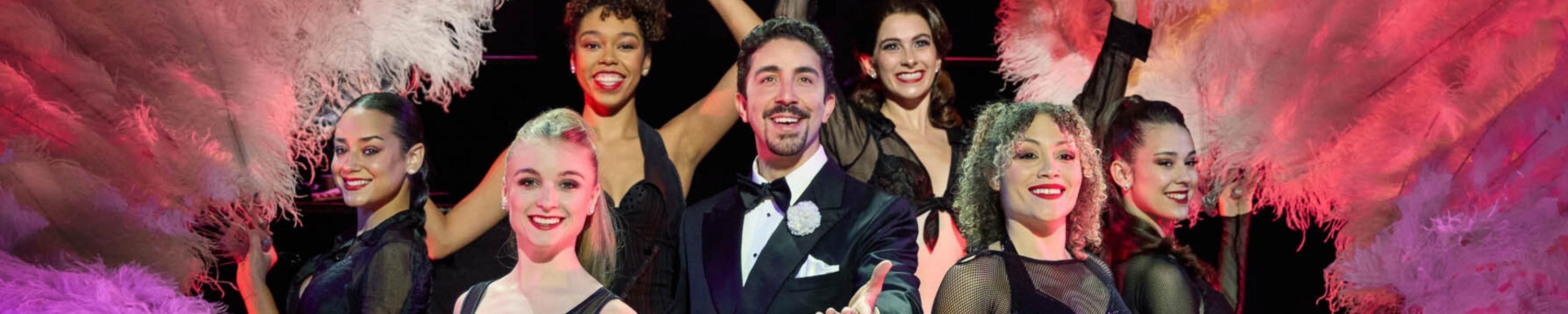 Chicago on stage - man in middle with burlesque dancers around