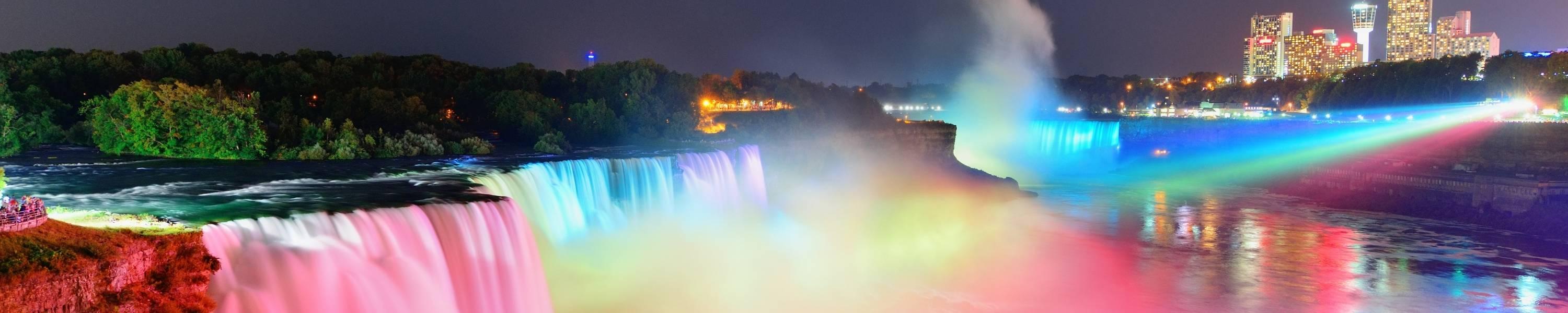 Niagara Falls lit at night by colorful lights