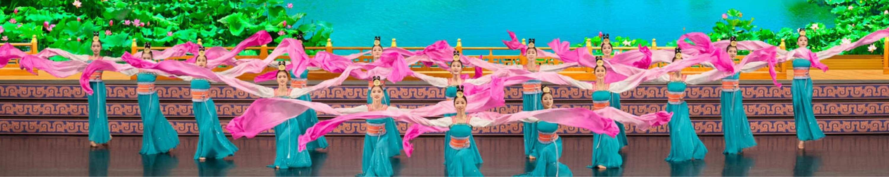 Shen Yun dancers on stage in bright blue and pink dresses