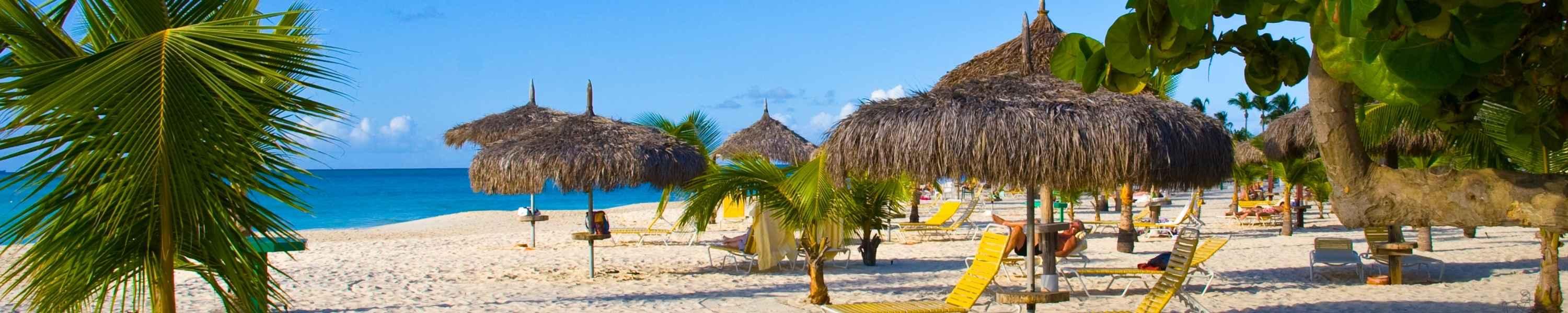 Beautiful beach with palapas and palmtrees, Eagle Beach, Aruba.