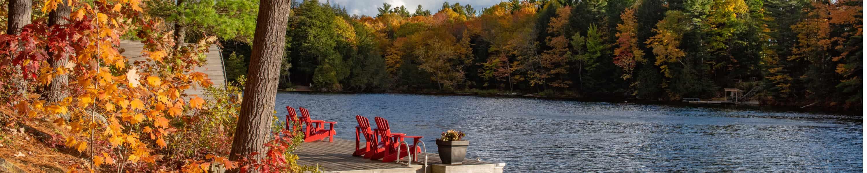 Muskoka chairs along a river