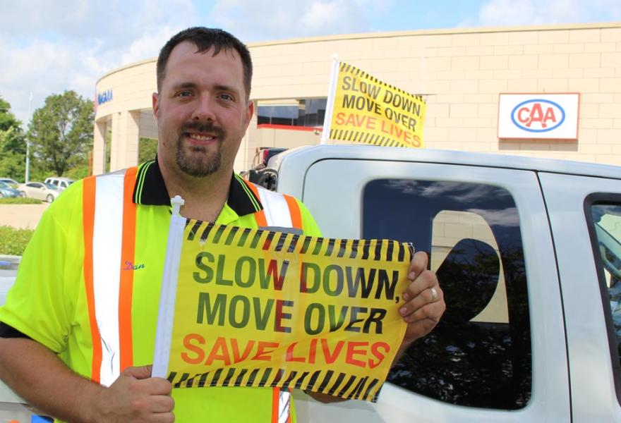 CAA Tow Truck Driver with Slow Down, Move Over flag