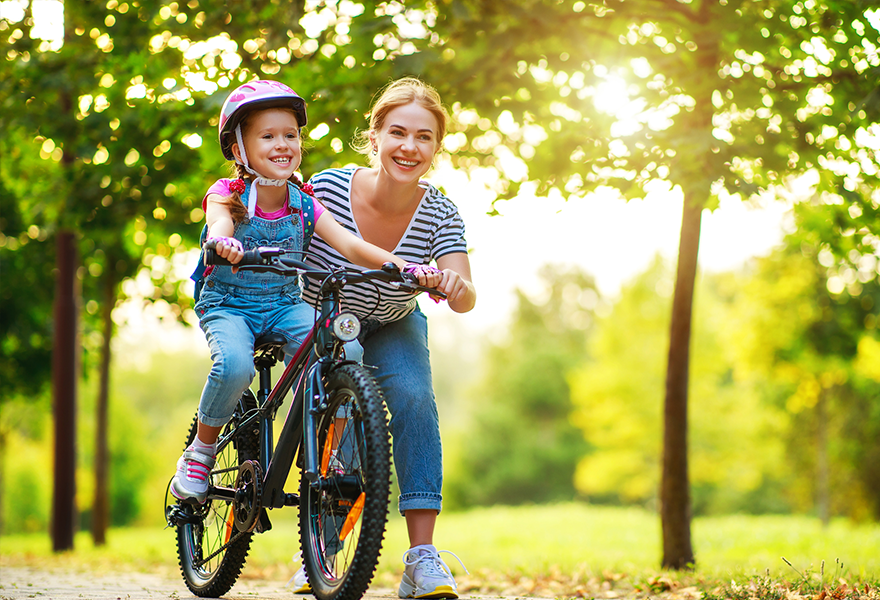 Young boy learning how to ride a bike