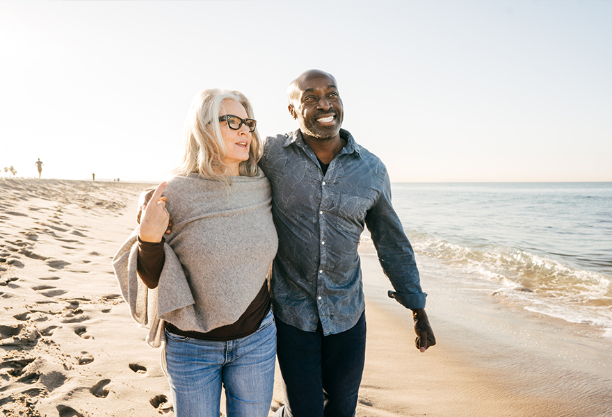 Couple walking on beach.