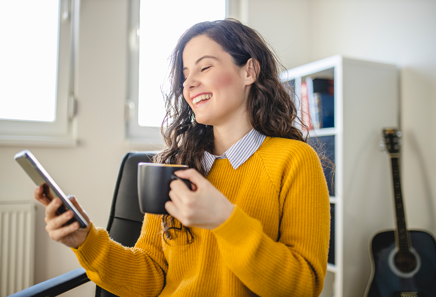 Woman reading CAA Magazine on phone