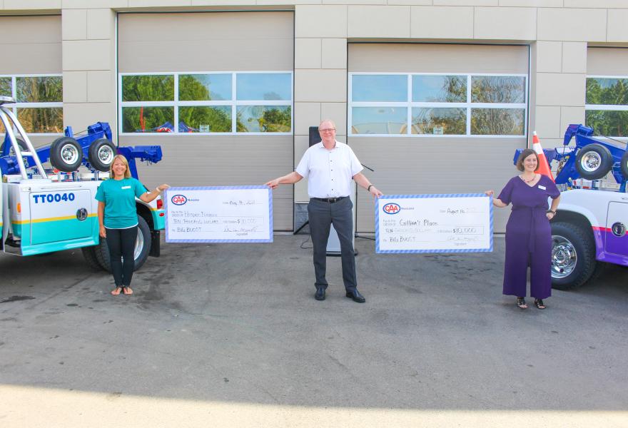 Alicia Merry, Director, Marketing, Communications and Fund Development, Hospice Niagara; Peter Van Hezewyk, President and CEO, CAA Niagara; and Nicole Regehr, Executive Director, Gillian’s Place posed with $10,000 donations from CAA Niagara at the 2021 Community Boost truck unveiling event