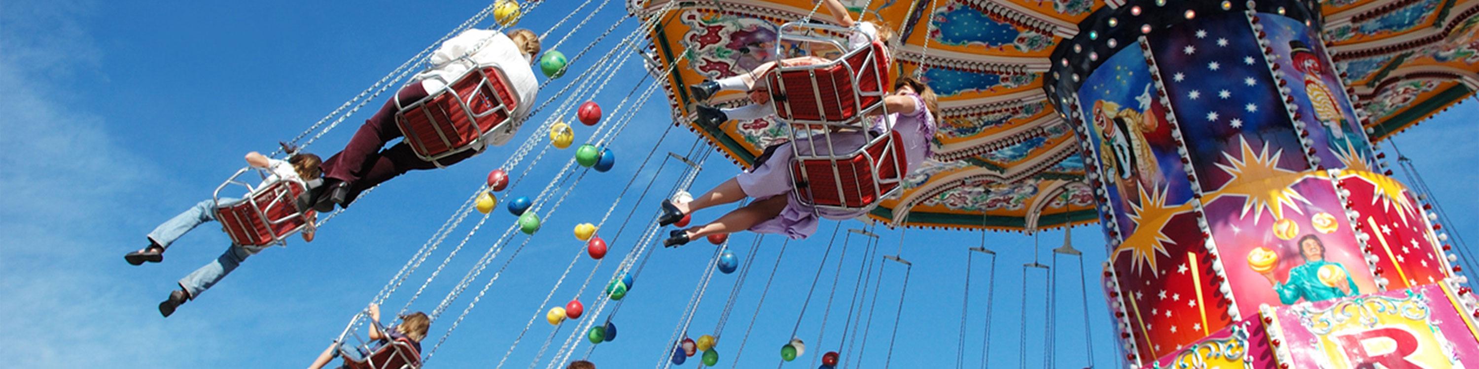 Families at the fair on a swing ride 