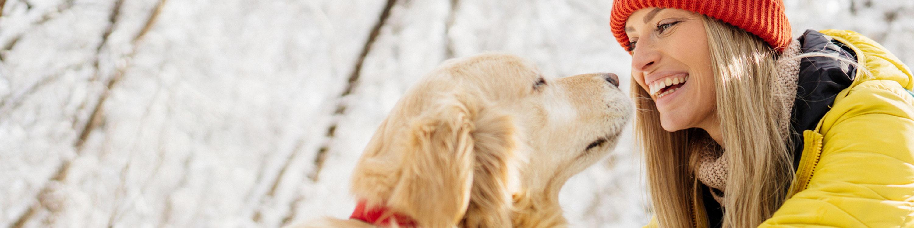 Woman and dog outdoors in snow
